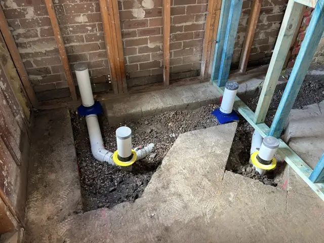 Termite collars sealed around slab pipe penetrations on a Sydney build