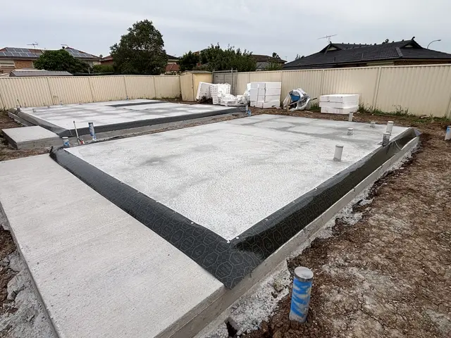Termite barrier membrane wrapped around a new slab edge