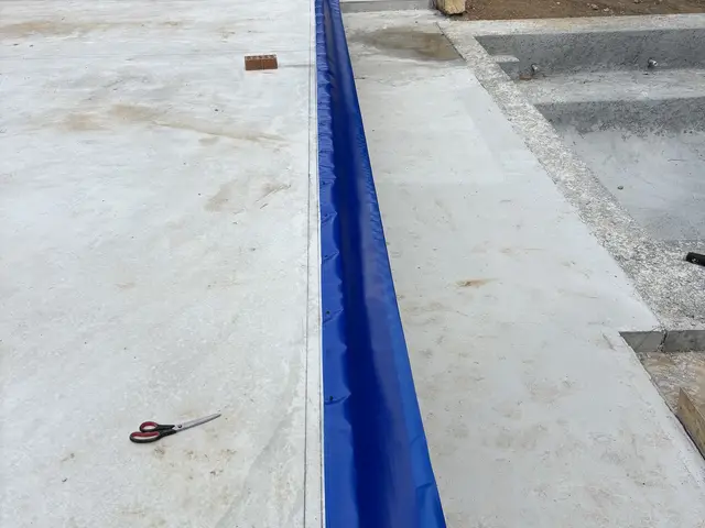Termite barrier membrane running the length of a slab edge
