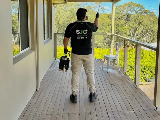 SJG technician treating the eaves from a strata unit balcony